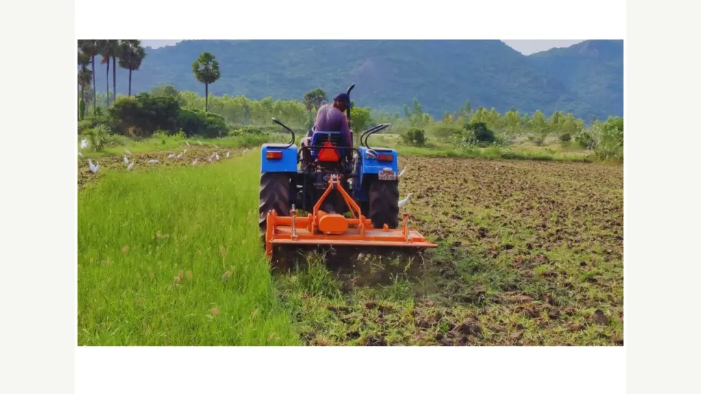 Rotavator working behind a tractor in the field